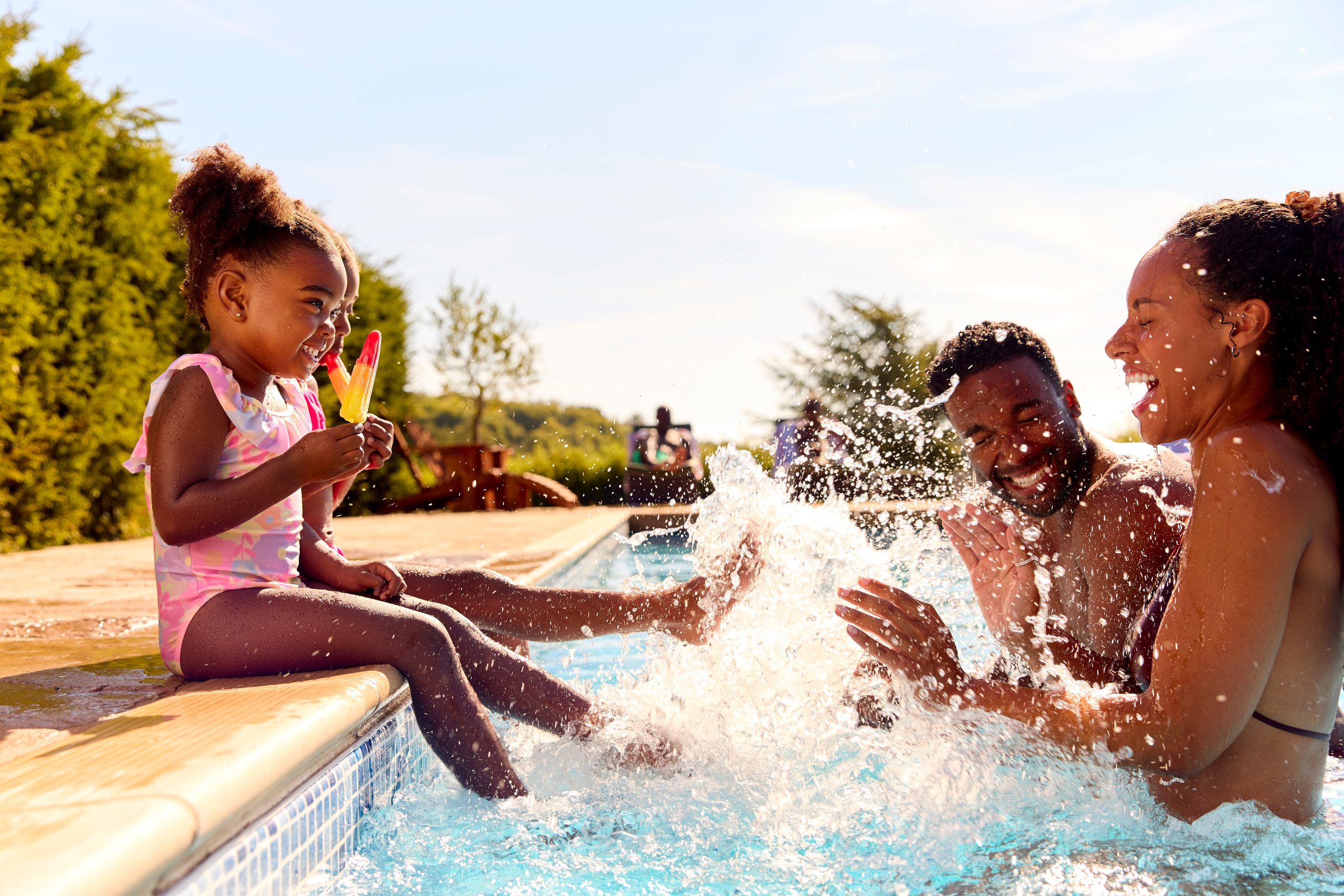 Family enjoying a clean, well-maintained residential swimming pool during summer vacation in Florida